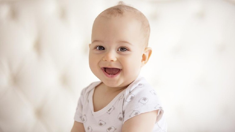 childhood, babyhood and people concept - portrait of joyful baby boy.