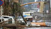 Banjir Bandang Jepang Tewaskan 20 Orang A man stands watch as debris and mud flown in a road in Hitoyoshi, Kumamoto prefecture, southwestern Japan, Sunday, July 5, 2020. Heavy rain in the Kumamoto region triggered flooding and mudslides Saturday and left dozens still being stranded at their homes and other facilities. (Takuto Kaneko/Kyodo News via AP)