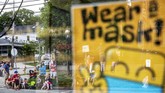 Libur Akhir Pekan di Amerika Parade goers are reflected in a storefront window posting a sign for customers to wear face masks before a Fourth of July parade begins Saturday, July 4, 2020, in Bristol, R.I. The town, which lays claim to the nation's oldest Independence Day celebration in the country, held a vehicle-only scaled down version of its annual parade Saturday due to the coronavirus pandemic. (AP Photo/David Goldman)