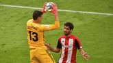 Athletic Bilbao vs Real Madrid Real Madrid's goalkeeper Thibaut Courtois stops the ball next to Athletic Bilbao's Raul Garcia during the Spanish La Liga soccer match between Athletic Club and Real Madrid at the San Manes stadium in Bilbao, Spain, Sunday, July 5, 2020. (AP Photo/Alvaro Barrientos)