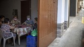 Buruh Migran Spanyol Kala Pandemi Women play cards inside a house as migrants seeking seasonal work harvesting fruit stand on the street in Fraga, Spain, Thursday, July 2, 2020. Authorities in northeast Spain have ordered the lockdown of a county around the city of Lleida due to worrying outbreaks of the COVID-19 virus. Catalan regional authorities announced Saturday, July 4, 2020 that as of noon local time movement will be restricted to and from the county of El Segriá around Lleida which is home to over 200,000 people. Residents will have until 4 p.m. to enter the area. The new outbreaks are linked to agricultural workers in the rural area. (AP Photo/Emilio Morenatti)