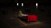 Buruh Migran Spanyol Kala Pandemi A bed is illuminated by a sun ray inside a sport center turned into temporary seasonal workers' shelter in Fraga, Huesca province, Spain, Thursday, July 2, 2020.Authorities in northeast Spain have ordered the lockdown of a county around the city of Lleida due to worrying outbreaks of the COVID-19 virus. Catalan regional authorities announced Saturday, July 4, 2020 that as of noon local time movement will be restricted to and from the county of El Segriá around Lleida which is home to over 200,000 people. Residents will have until 4 p.m. to enter the area. The new outbreaks are linked to agricultural workers in the rural area. (AP Photo/Emilio Morenatti)