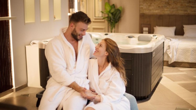 Today we will just enjoy. Young couple in spa apartment.