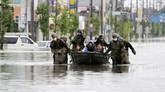Pencarian Korban Banjir di Jepang Japan Self Defense Force members rescue residents on a boat on a flooded road hit by heavy rain in Omuta, Fukuoka prefecture, southern Japan Tuesday, July 7, 2020. Rescue operations continued and rain threatened wider areas of the main island of Kyushu. (Juntaro Yokoyama/Kyodo News via AP)