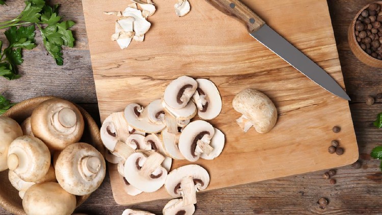 Flat lay composition with fresh champignon mushrooms on wooden table