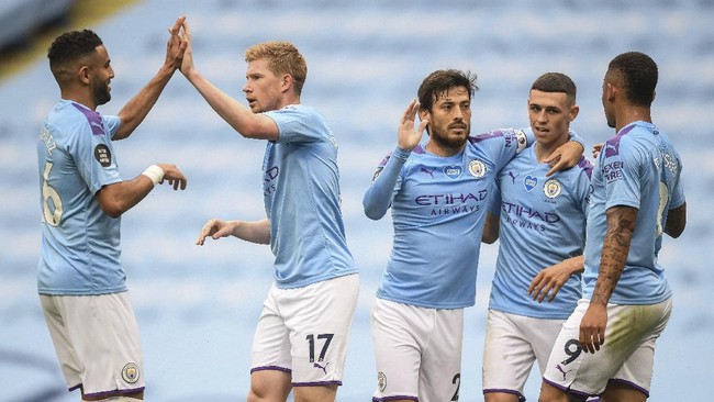 Manchester City players celebrate after scoring their second goal during the English Premier League soccer match between Manchester City and Newcastle at the Ethiad Stadium in Manchester, England, Wednesday, July 8, 2020. (Michael Regan/Pool via AP)