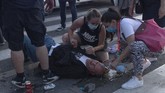 demo rusuh serbia People tend to an injured man during a protest in Belgrade, Serbia, Wednesday, July 8, 2020. Police have fired tear gas at protesters in Serbia's capital during the second day of demonstrations against the president's handling of the country's coronavirus outbreak. President Aleksandar Vucic backtracked on his plans to reinstate a coronavirus lockdown in Belgrade this week, but it didn't stop people from firing flares and throwing stones while trying to storm the downtown parliament building. (AP Photo/Marko Drobnjakovic)