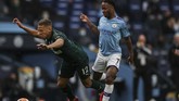 Manchester City vs Newcastle Newcastle's Dwight Gayle, left, is tackled by Manchester City's Raheem Sterling during the English Premier League soccer match between Manchester City and Newcastle at the Ethiad Stadium in Manchester, England, Wednesday, July 8, 2020. (Lee Smith/Pool via AP)