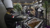 SIMULASI RESEPSI PERNIKAHAN NORMAL BARU Juru masak mengenakan masker, pelindung wajah dan sarung tangan saat melayani tamu undangan pada simulasi resepsi pernikahan di masa normal baru antara Kumala dan Putri di Hotel Royal Singosari Cendana, Surabaya, Jawa Timur, Senin (6/7/2020). Kegiatan simulasi resepsi pernikahan tersebut bertujuan untuk mengedukasi masyarakat tentang pentingnya penerapan protokol kesehatan dalam acara pernikahan guna mencegah penyebaran dan penularan COVID-19 di masa normal baru. ANTARA FOTO/Moch Asim/wsj.