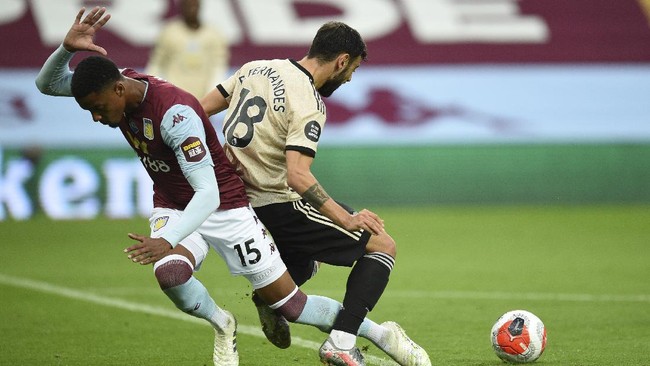 Manchester United's Bruno Fernandes, right, is fouled by Aston Villa's Ezri Konsa during the English Premier League soccer match between Aston Villa and Manchester United at Villa Park in Birmingham, England, Thursday, July 9, 2020. (AP Photo/Oli Scarff,Pool)