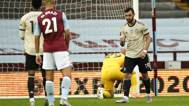 Manchester United's Bruno Fernandes reacts after scoring his team's first goal from the penalty spot during the English Premier League soccer match between Aston Villa and Manchester United at Villa Park in Birmingham, England, Thursday, July 9, 2020. (AP PhotoAndrew Boyers,Pool)
