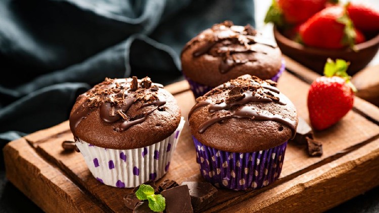 Chocolate muffins on wooden board. Sweet food. Tasty chocolate cakes