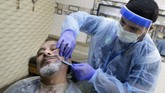 Kasus Virus Corona Meningkat di Arab Saudi A barber wears a protective face shield and gloves to help curb the spread of the coronavirus, as he shaves the beard of a customer at a local barber shop in Jiddah, Saudi Arabia, Sunday, June 28, 2020. (AP Photo/Amr Nabil)