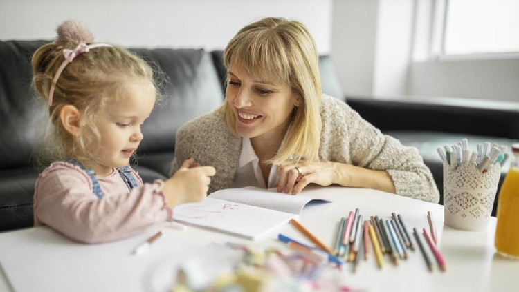 Happy mother and smiling daughter together painting  using marks