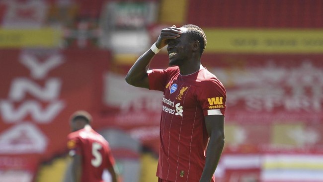 Liverpool's Sadio Mane reacts after missing a chance to score a goal during the English Premier League soccer match between Liverpool and Burnley at Anfield, Liverpool, England, Saturday, July 11, 2020. (Oli Scarff/ Pool via AP)
