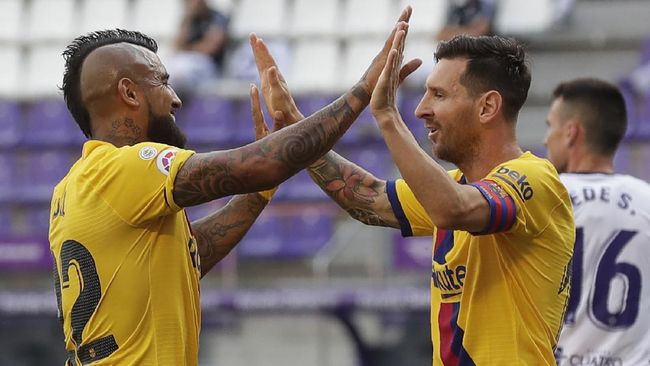 Barcelona Barcelona's Arturo Vidal, left, celebrates with his teammate Lionel Messi after scoring his side's first goal during the Spanish La Liga soccer match between Valladolid and FC Barcelona at the Jose Zorrilla stadium in Valladolid, Spain, Saturday, July 11, 2020. (AP Photo/Manu Fernandez)