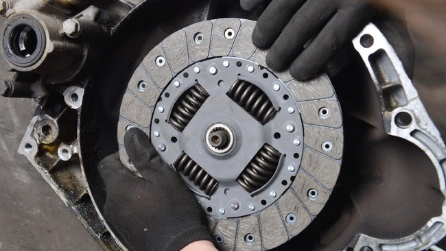 Car mechanic is changing Clutch