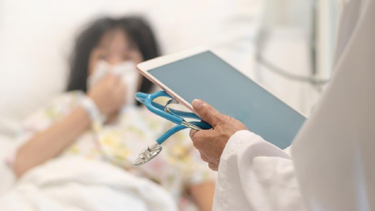 Professional general medical pediatrician doctor in white uniform gown visit Asia child patient with stethoscope and tablet computer chart. Physician check up Asian kid female inpatient in hospital children ward.