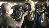 Kapal Perang Amerika Meledak In a photo provided by the U.S. Navy, sailors aboard the USS Bonhomme Richard don firefighting equipment to combat a fire aboard the ship at Naval Station San Diego on Sunday July 12, 2020. Twenty-one people suffered minor injuries in an explosion and fire Sunday on board a ship, military officials said. The blaze was reported shortly before 9 a.m., said Mike Raney, a spokesman for Naval Surface Force, U.S. Pacific Fleet. Seventeen sailors and four civilians were hospitalized with “non-life threatening injuries,” Raney said in a brief statement. (Petty Officer 1st Class Jason Kofonow/U.S. Navy via AP)