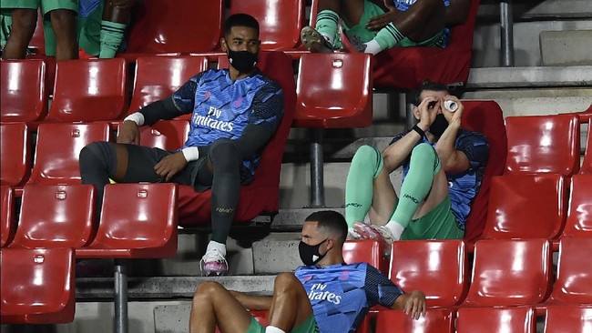 Real Madrid's Gareth Bale, right, gestures from the stands ahead of the Spanish La Liga soccer match between Granada and Real Madrid at the Los Carmenes stadium in Granada, Spain, Monday, July 13, 2020. (AP Photo/Jose Breton)