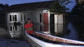 Korban Banjir Konawe Warga melintas dengan menggunakan perahu di dekat rumahnya yang terendam banjir di Desa Lalonggotomi, Konawe, Sulawesi Tenggara, Rabu (15/7/2020). Luapan Sungai Konaweha mengakibatkan 1.669 jiwa mengungsi sementara 1.235 rumah terendam banjir yang tersebar di 11 Kecamatan di Kabupaten Konawe. ANTARA FOTO/Jojon/foc.