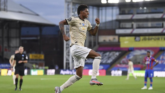 Manchester United's Marcus Rashford celebrates after scoring the opening goal during the English Premier League soccer match between Crystal Palace and Manchester United at Selhurst Park in London, England, Thursday, July 16, 2020. (AP Photo/Justin Setterfield, Pool)