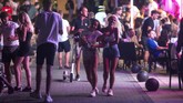Mallorca, Pulau Pesta di Spanyol Tourists walk at the resort of Magaluf on the Spanish Balearic island of Mallorca, Spain, Thursday morning, July 16, 2020. Authorities in Spain's Balearic Islands are pulling the plug on endless drunken nights to the beat of techno music by closing bars and nightclubs in beachfront areas popular with young and foreign visitors. (AP Photo/Joan Mateu)