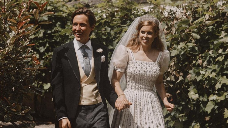 CORRECTING DATE OF PHOTO TO FRIDAY JULY 17, 2020 : In this photograph released on Sunday July 19, 2020, by the Royal Communications of Princess Beatrice and Edoardo Mapelli Mozzi, showing Britain's Princess Beatrice and Edoardo Mapelli Mozzi as they pose for a photo Friday July 17, 2020, after their wedding at The Royal Chapel of All Saints at Royal Lodge, Windsor, England.  The queen’s granddaughter and the property tycoon were married on Friday in the Royal Chapel of All Saints at Royal Lodge, Windsor. The 94-year-old British monarch and her 99-year-old husband Prince Philip attended, along with the parents and siblings of the bride and groom. (Benjamin Wheeler/Royal Communications of Princess Beatrice and Edoardo Mapelli Mozzi via AP)