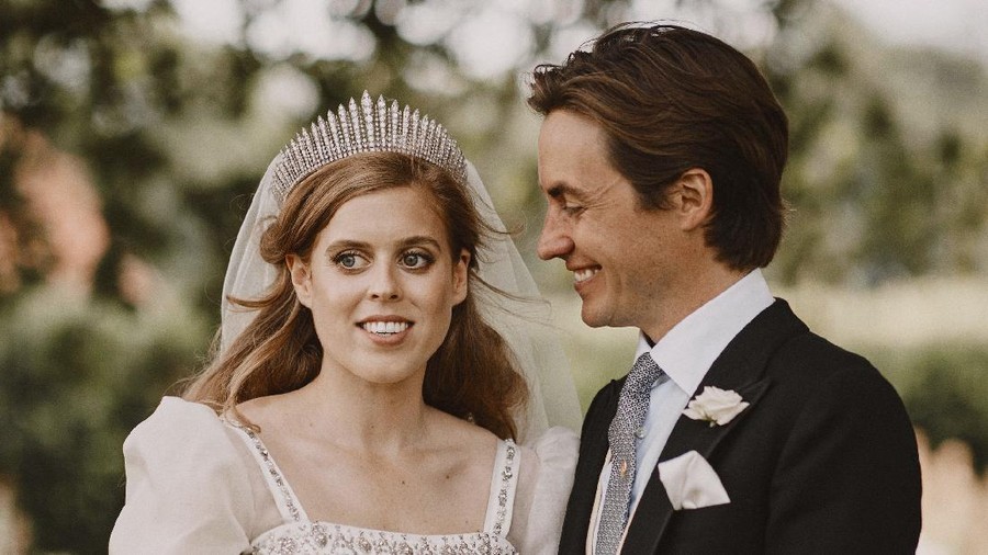 CORRECTING DATE OF PHOTO TO FRIDAY JULY 17, 2020 : In this photograph released on Sunday, July 19, 2020, by the Royal Communications of Princess Beatrice and Edoardo Mapelli Mozzi, showing Britain's Princess Beatrice and Edoardo Mapelli Mozzi as they pose for a photo on Friday July 17, 2020, after their wedding at The Royal Chapel of All Saints at Royal Lodge, Windsor, England. The queen’s granddaughter and the property tycoon were married on Friday in the Royal Chapel of All Saints at Royal Lodge, Windsor.  The 94-year-old British monarch and her 99-year-old husband Prince Philip attended, along with the parents and siblings of the bride and groom. (Benjamin Wheeler/Royal Communications of Princess Beatrice and Edoardo Mapelli Mozzi via AP)