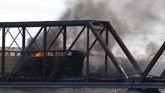 FOTO: Kereta Anjlok di atas Danau Buatan Arizona Sebanyak 12 rangkaian kereta barang anjlok dan terbakar di atas jembatan danau buatan di Phoenix, Arizona, Amerika Serikat.