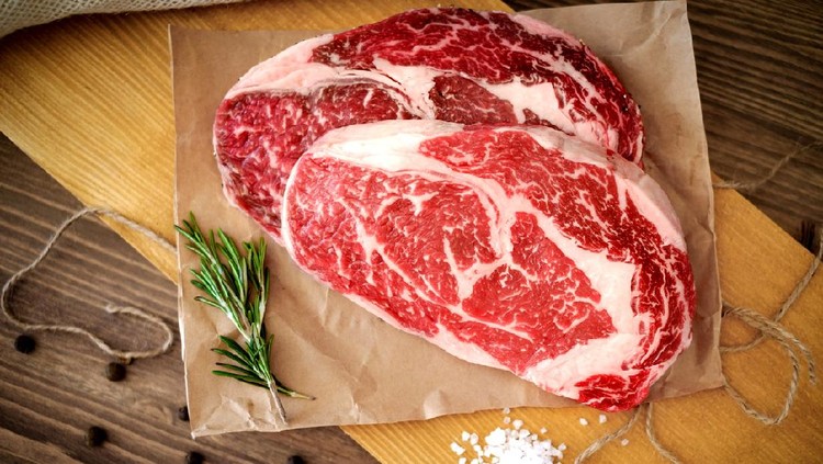 Ilustrasi daging sapi Two raw rib eye steak on a wooden Board on a table prepared for the grill. Top view rustic style