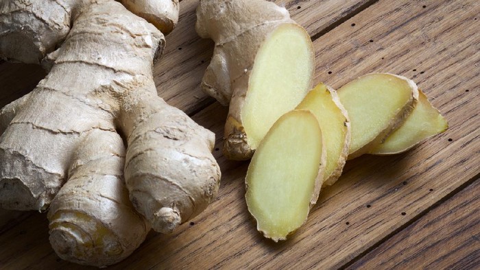 Root of ginger on wooden table