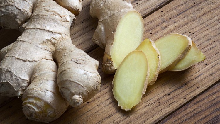 Root of ginger on wooden table