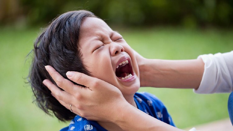Little asian boy crying bitterly at outdoor. Mom comforting to a crying boy.