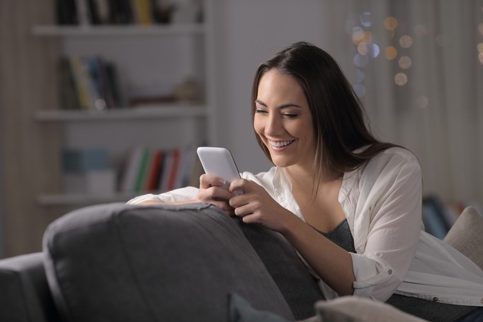 Close-up portrait of her she nice attractive lovely cute charming lovable sweet shine cheerful cheery wavy-haired girl browsing chatting at industrial loft wooden brick style interior room.