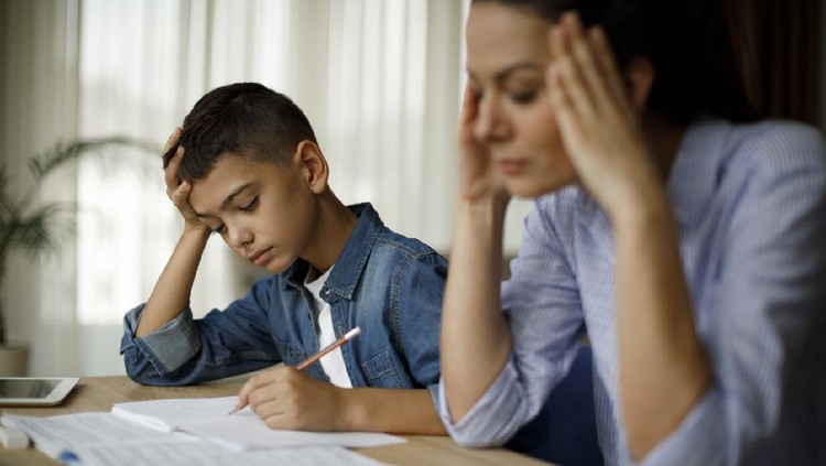 Teenage boy having problems in finishing homework