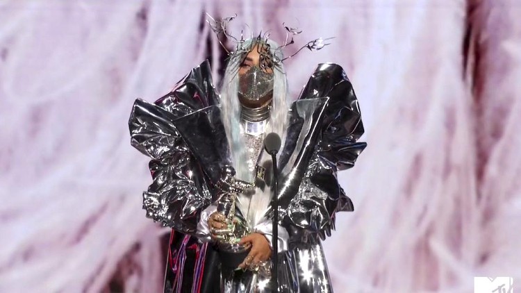 This combination photo of video grabs by MTV, issued Sunday, Aug. 30, 2020, shows Lady Gaga wearing masks during the MTV Video Music Awards. (MTV via AP)