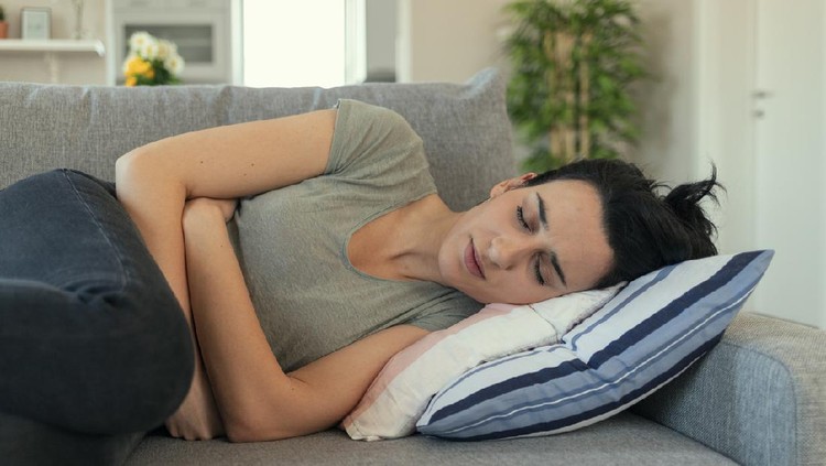 sembelit Woman With Abdomen Problems in Bed, She Use Hands to Massage Painful Place. People with diarrhea problem concept. Woman with menstrual pain