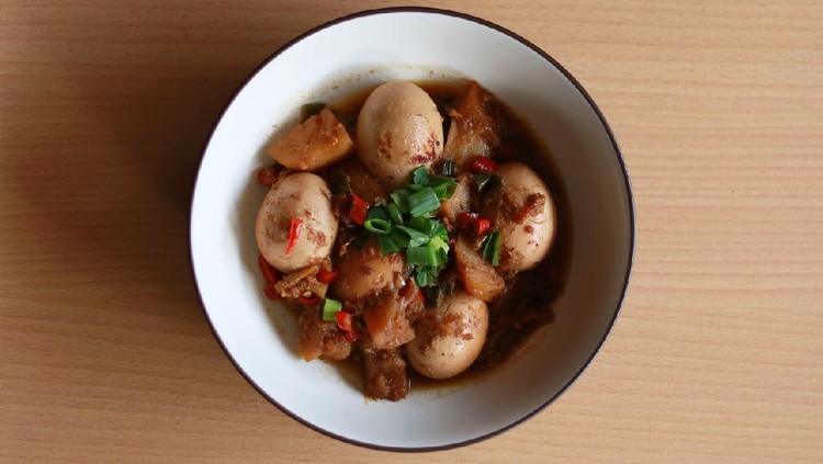 Egg semur or Indonesian stew. Egg in sweet soy sauce. With wood background