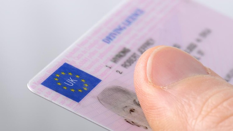 Ilustrasi SIM Holding out a driving license