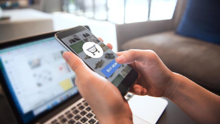 Online payment. Hands of woman using mobile smartphone and laptop computer for online shopping.