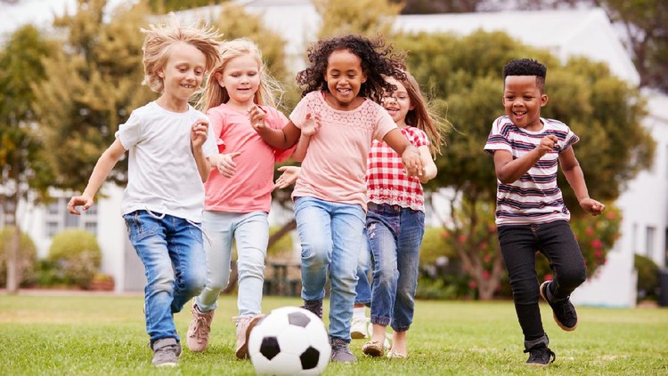 anak main Group Of Children Playing Football With Friends In Park