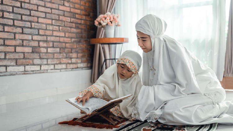 mother and kid reading quran together at home
