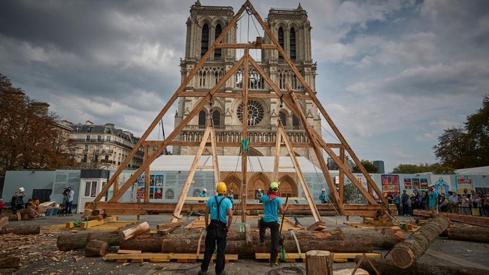 PARIS, FRANCE - SEPTEMBER 19: A member of the Charpentiers sans Frontièrs (Carpenters without Borders) works on the reconstruction of one of the missing timber frames of Notre-Dame Cathedral that was destroyed by the fire in front of the Cathedral on September 19, 2020 in Paris, France. Part of the 37th edition of the European Heritage Days, the iconic Parisian landmark aims at informing the public of the reconstruction plans related to the April 15, 2019 fire and aims to imporve the public's knowledge of Notre-Dame's architecture and history. The extensive damage to the roof and spire of the 13th-century Notre Dame de Paris cathedral have proven reconstruction process to be much more complex than many anticipated. (Photo by Kiran Ridley/Getty Images)