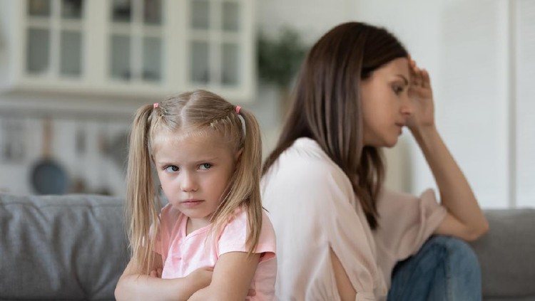Naughty stubborn little child daughter and worried mum avoid talk after argument sit turn back on sofa, fussy preschool kid girl sulking ignore mother at home, parents with children conflicts concept