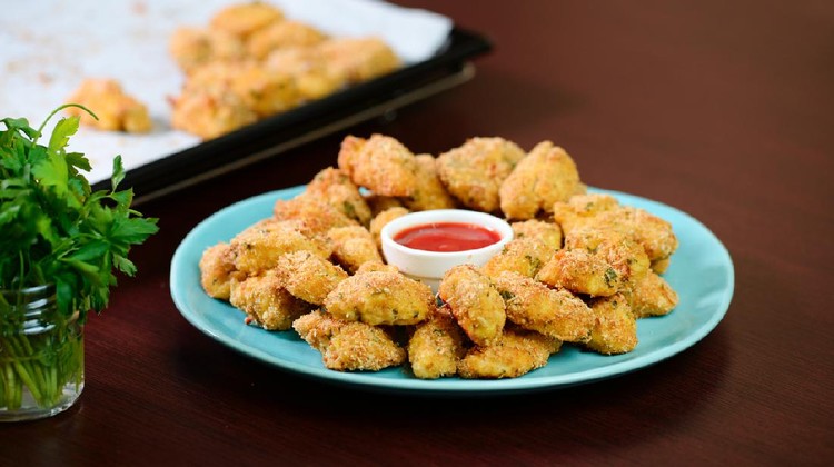 Ilustrasi nugget ayam Fried crispy chicken nuggets with ketchup on the plate.