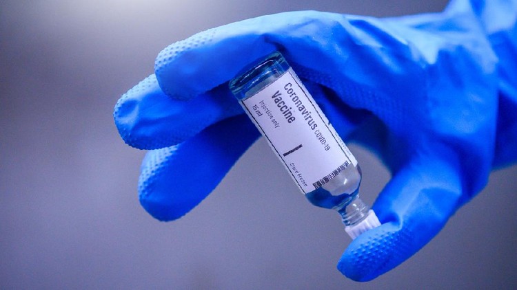 Vaksin Covid-19 Image of Hand holds Coronavirus Covid-19 Vaccine glass bottle.