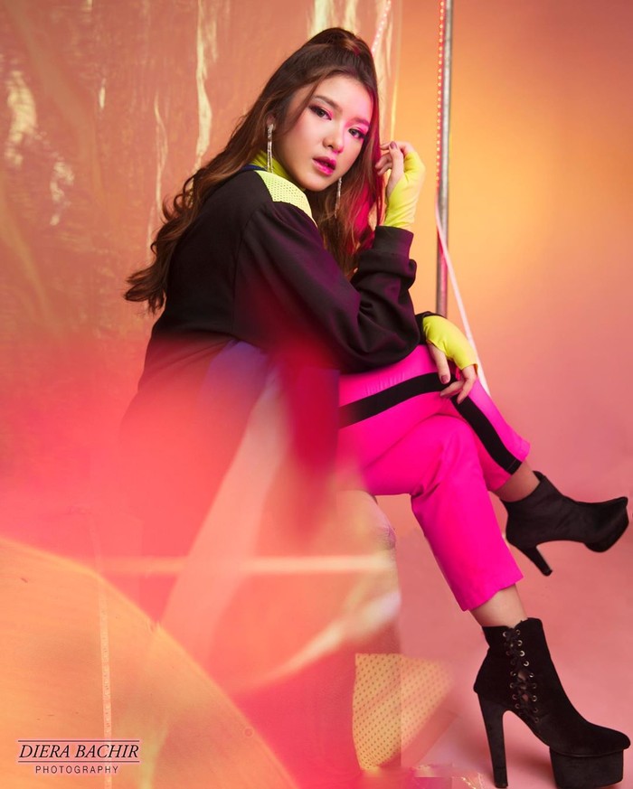 Memadukan warna-warna cerah jadi tips terbaik untuk dapatkan nuansa tren fashion 90-an. Cukup memadukan outwear oversized warna hitam dengan detail potongan polkadot di bagian bahu dan inner warna kuning cerah. Mix and match dengan celana side stripe warna kuning dengan hitam membuat tampilan lebih sophisticated (Foto: www.instagram.com/tiaraandini/)