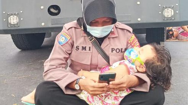 Aipda Ismi Andri Nurwati viral menggendong anak saat mengamankan demo sengketa Pilkada Dompu, NTB. Aipda Ismi Andri Nurwati viral menggendong anak saat mengamankan demo sengketa Pilkada Dompu, NTB.