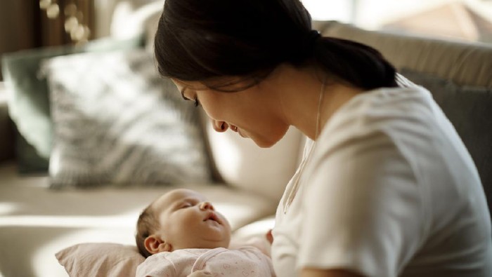 Mother holding her sleeping baby girl